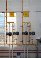 a room with pipes and a sign on the wall