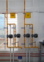 a room with pipes and a sign on the wall