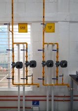 a room with pipes and a sign on the wall