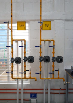 a room with pipes and a sign on the wall