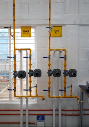 a room with pipes and a sign on the wall