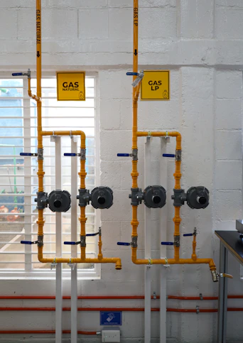 a room with pipes and a sign on the wall