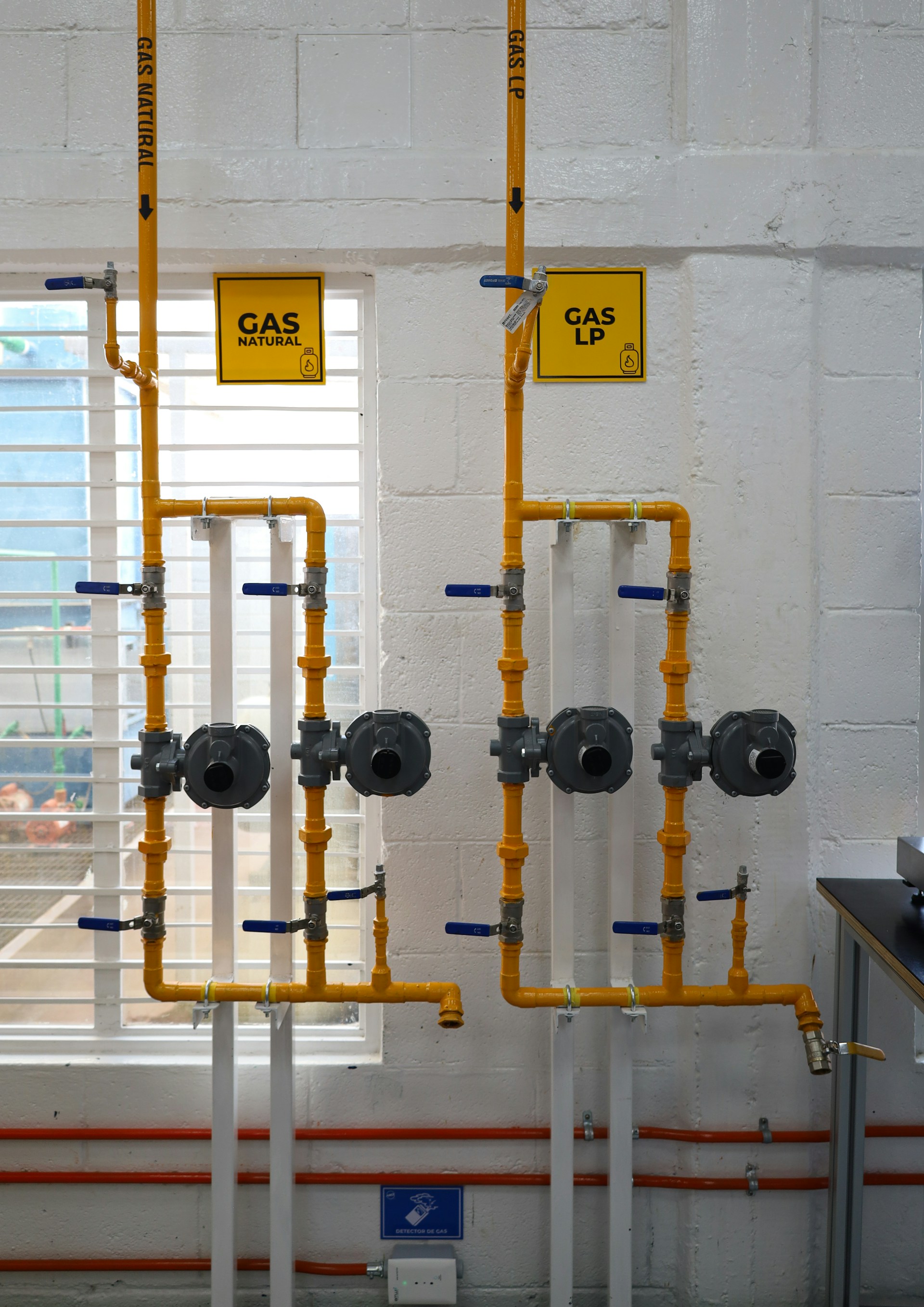 a room with pipes and a sign on the wall