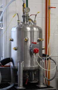 a large metal tank sitting on top of a metal shelf