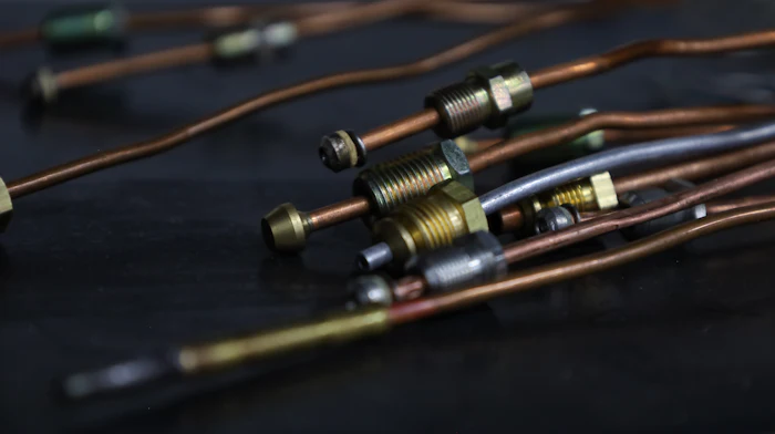 Close-up of copper refrigerant line fittings