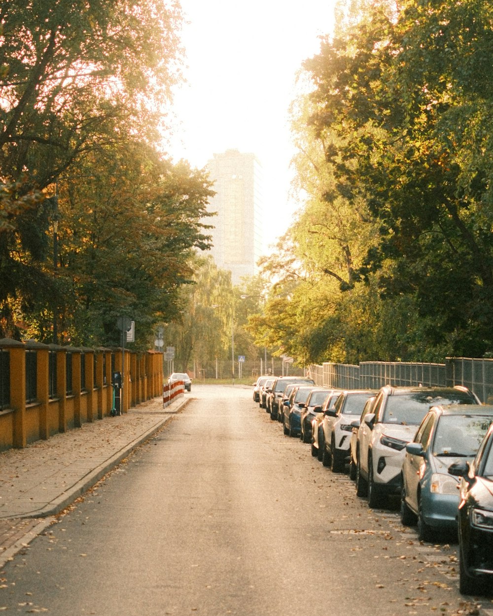 a row of parked cars on the side of a road