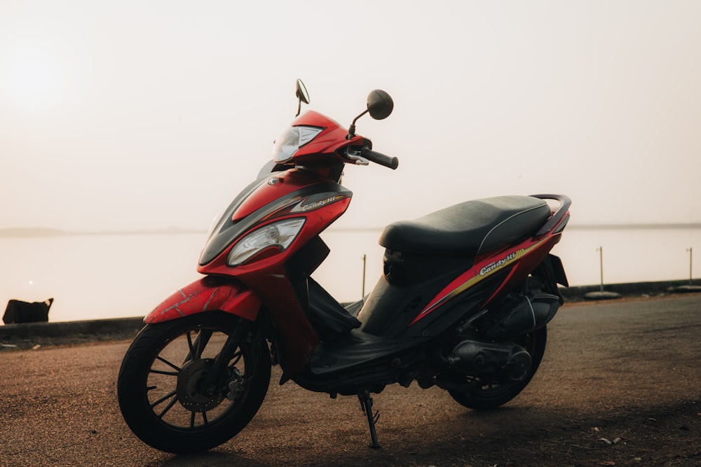 a red scooter parked on the side of a road