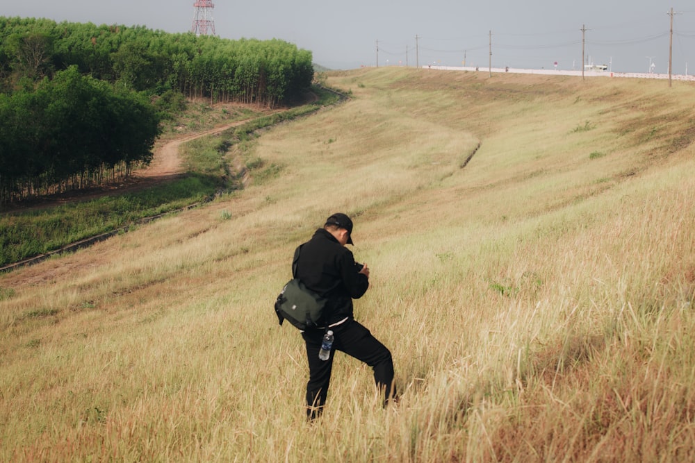 a man in a field with a camera