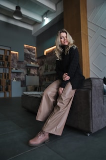 a woman sitting on a couch in a room