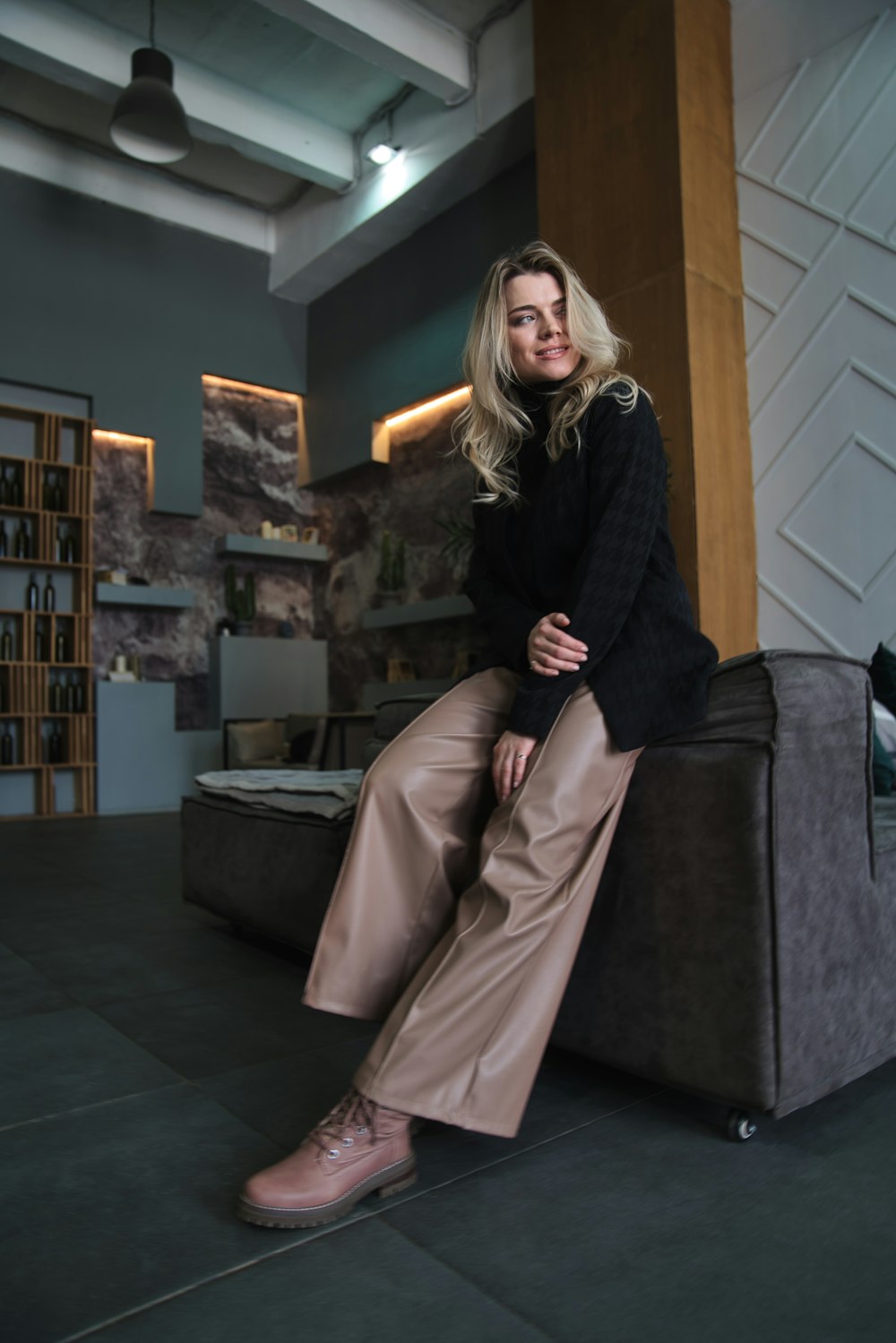 a woman sitting on a couch in a room