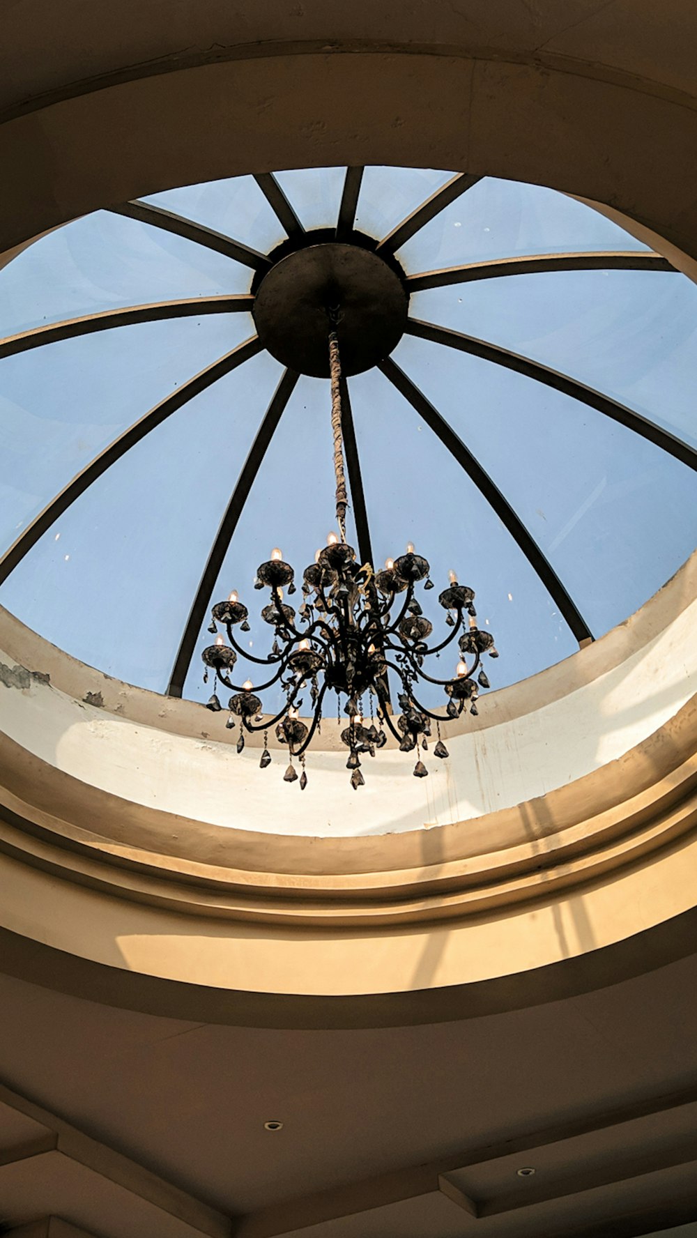 a chandelier hanging from the ceiling of a circular room