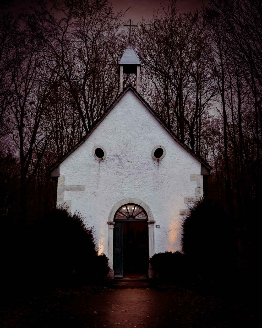 a white church with a clock tower on top of it