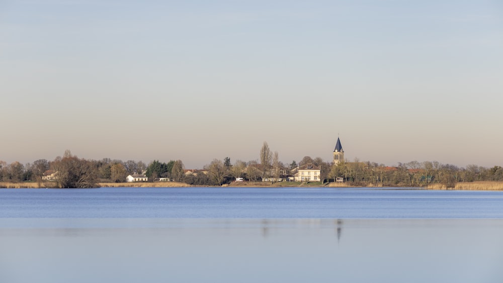 a large body of water with a church in the background