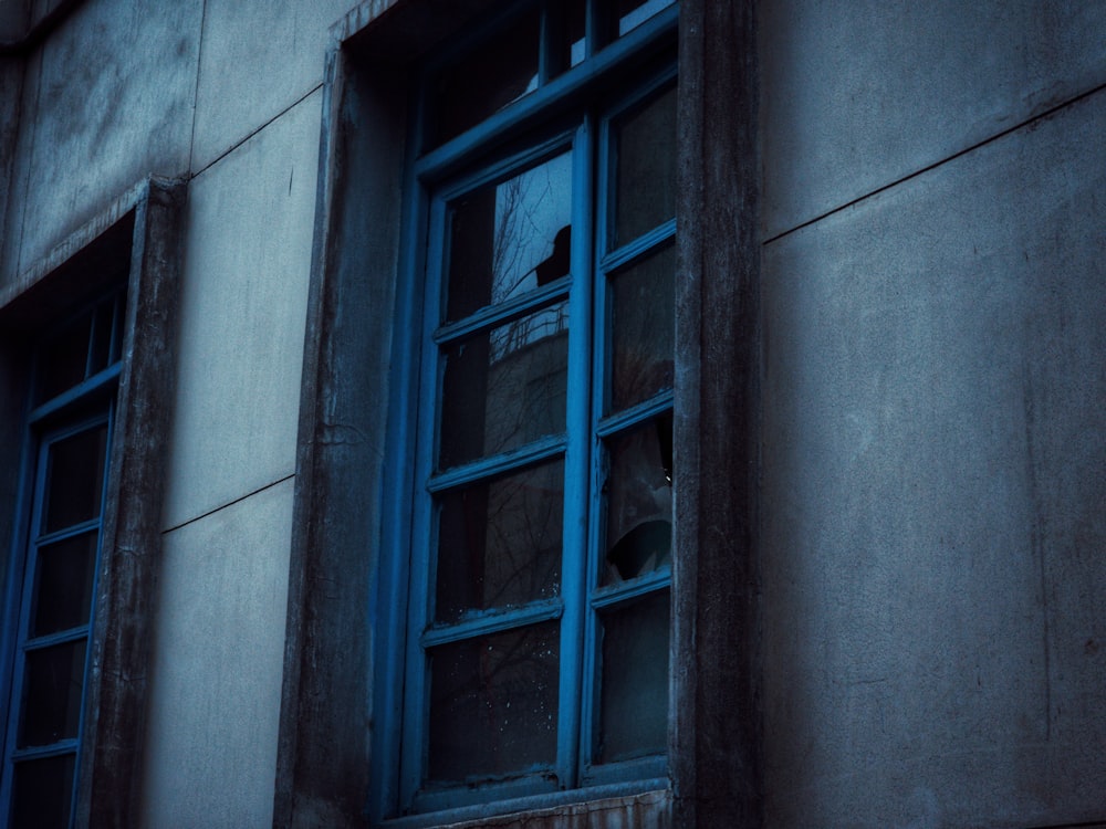 a blue window on the side of a building