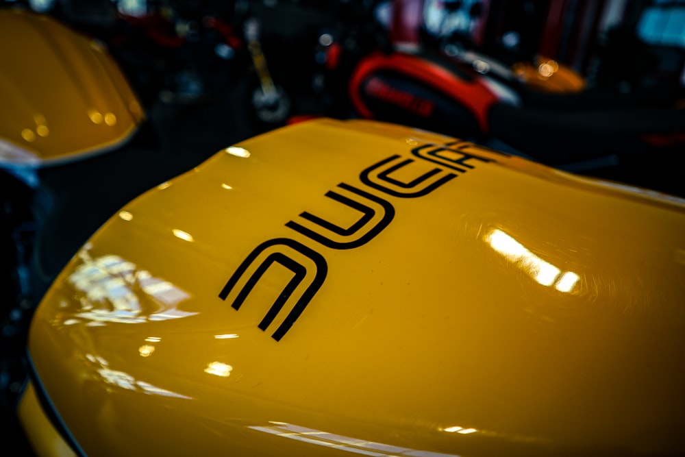 a close up of the side of a yellow motorcycle