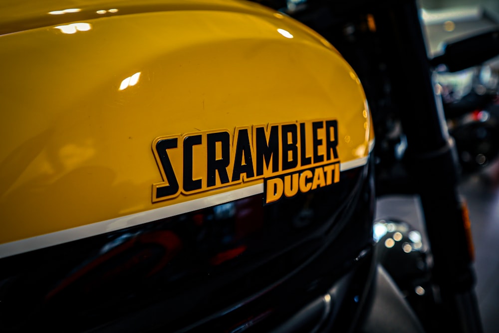a close up of a yellow scrambler ducati motorcycle