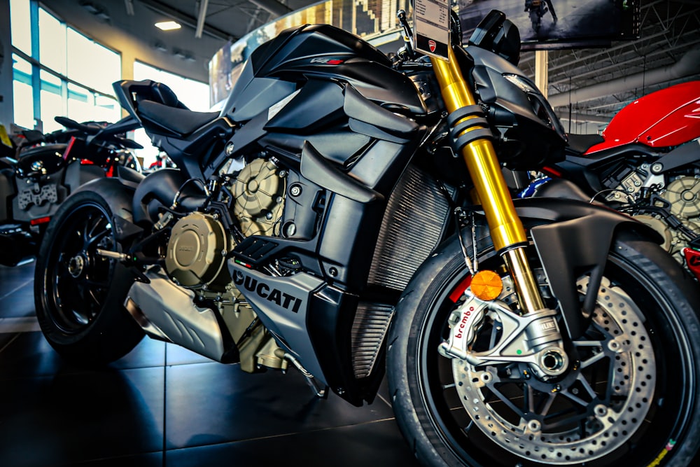 a motorcycle parked inside of a building next to other motorcycles