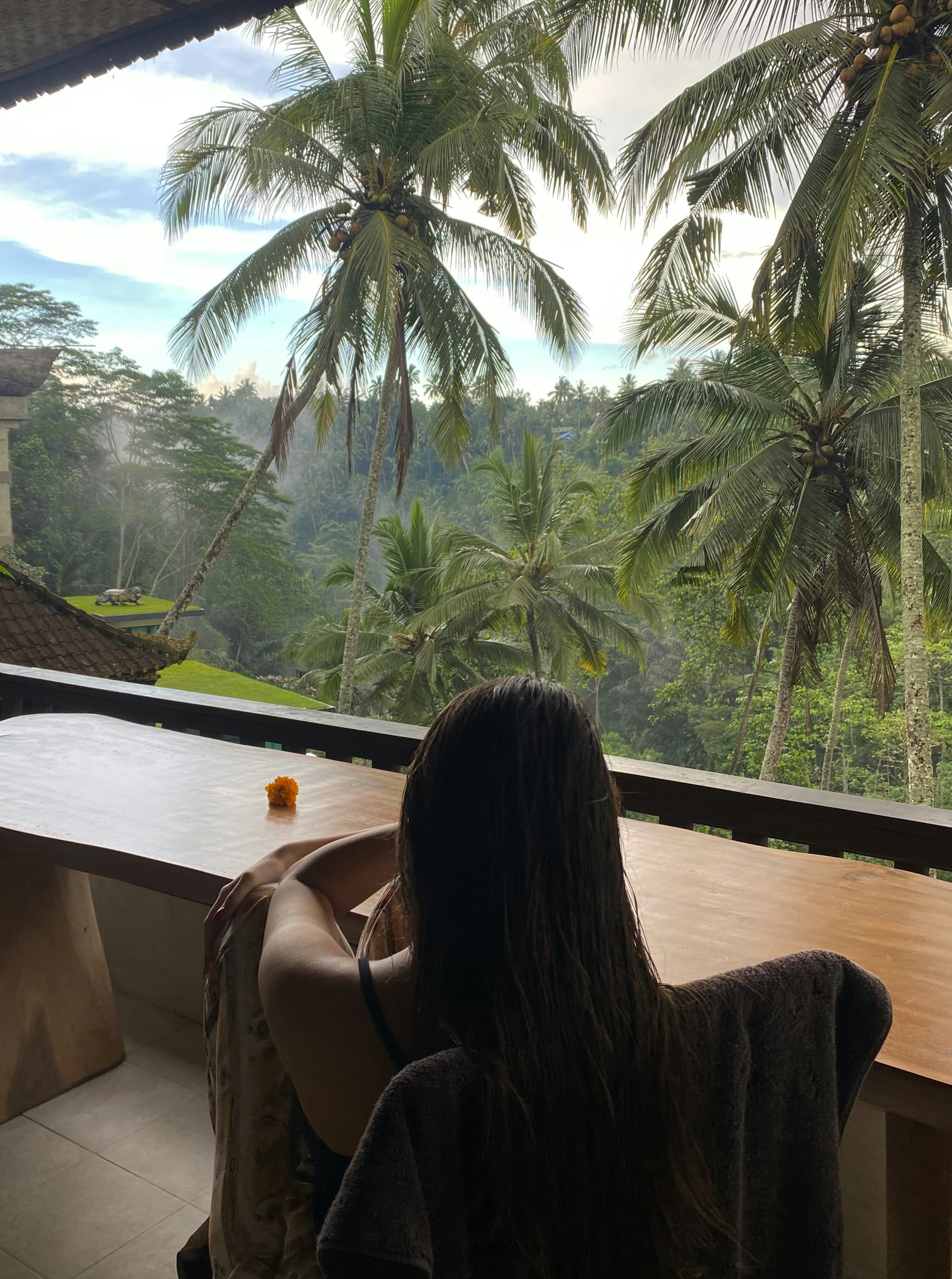 a woman sitting in a chair looking out a window