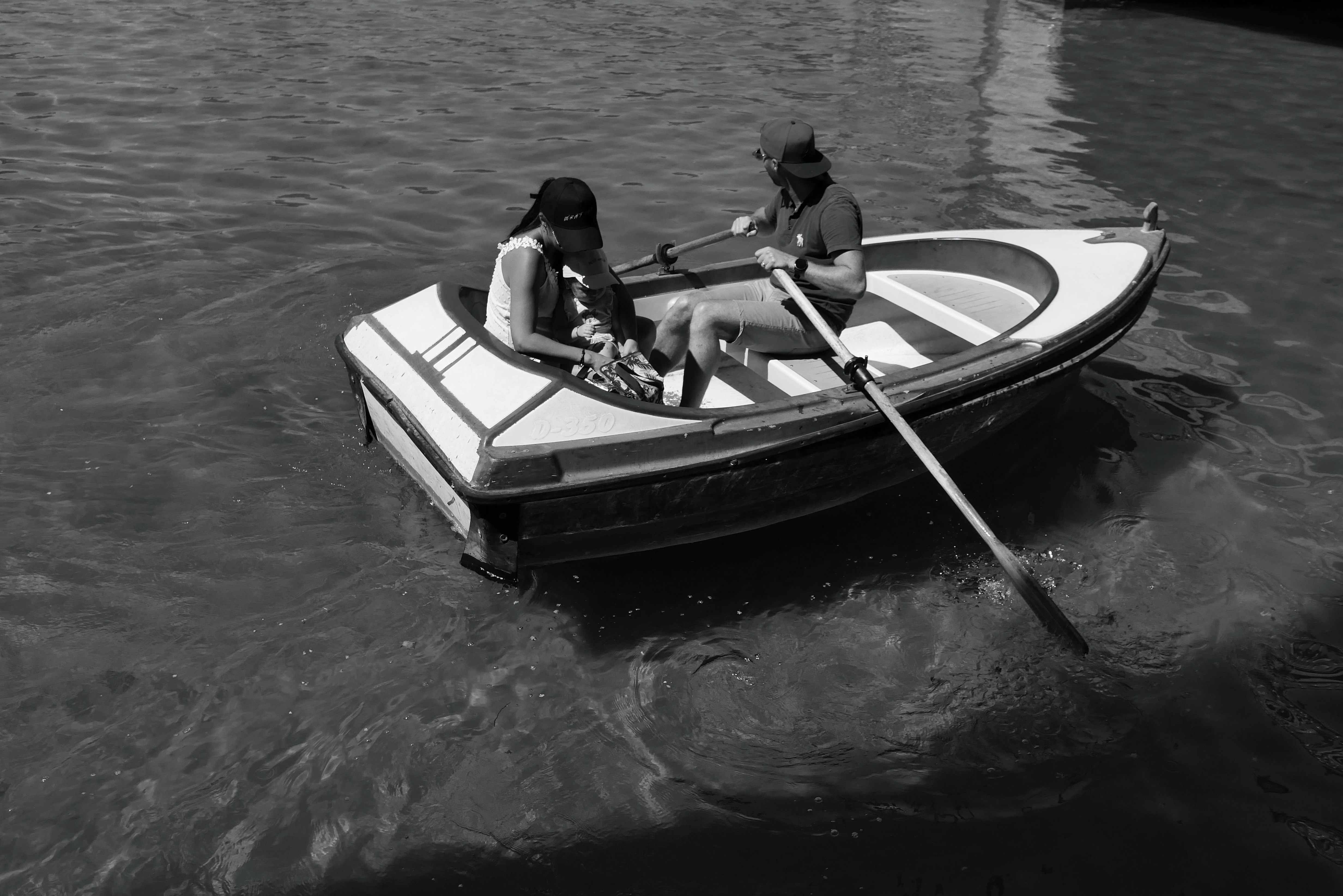 two people in a small boat on a body of water