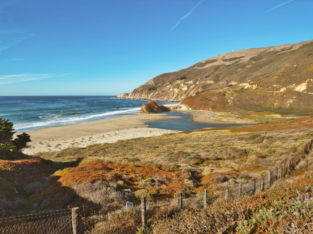 a view of a beach with a mountain in the background