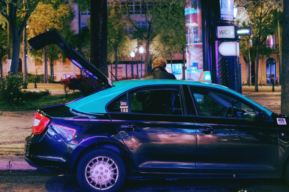 a blue car parked on the side of the road