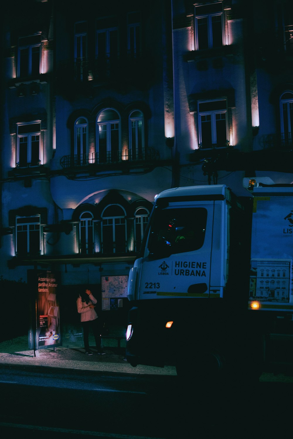 a truck parked in front of a building at night