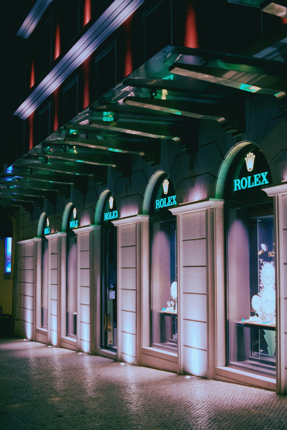 a row of storefronts with lit up windows