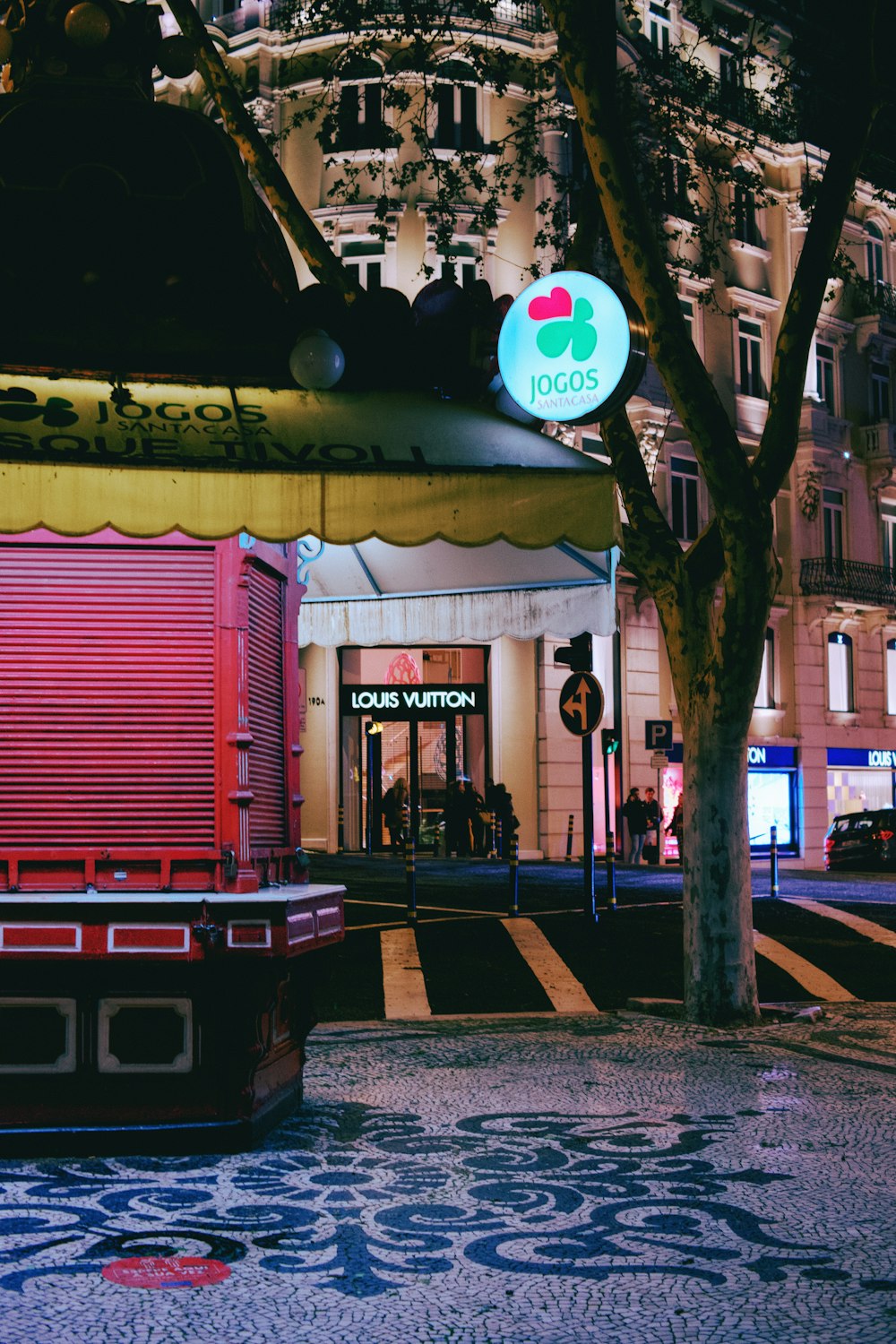 a street corner with a red truck parked in front of a building