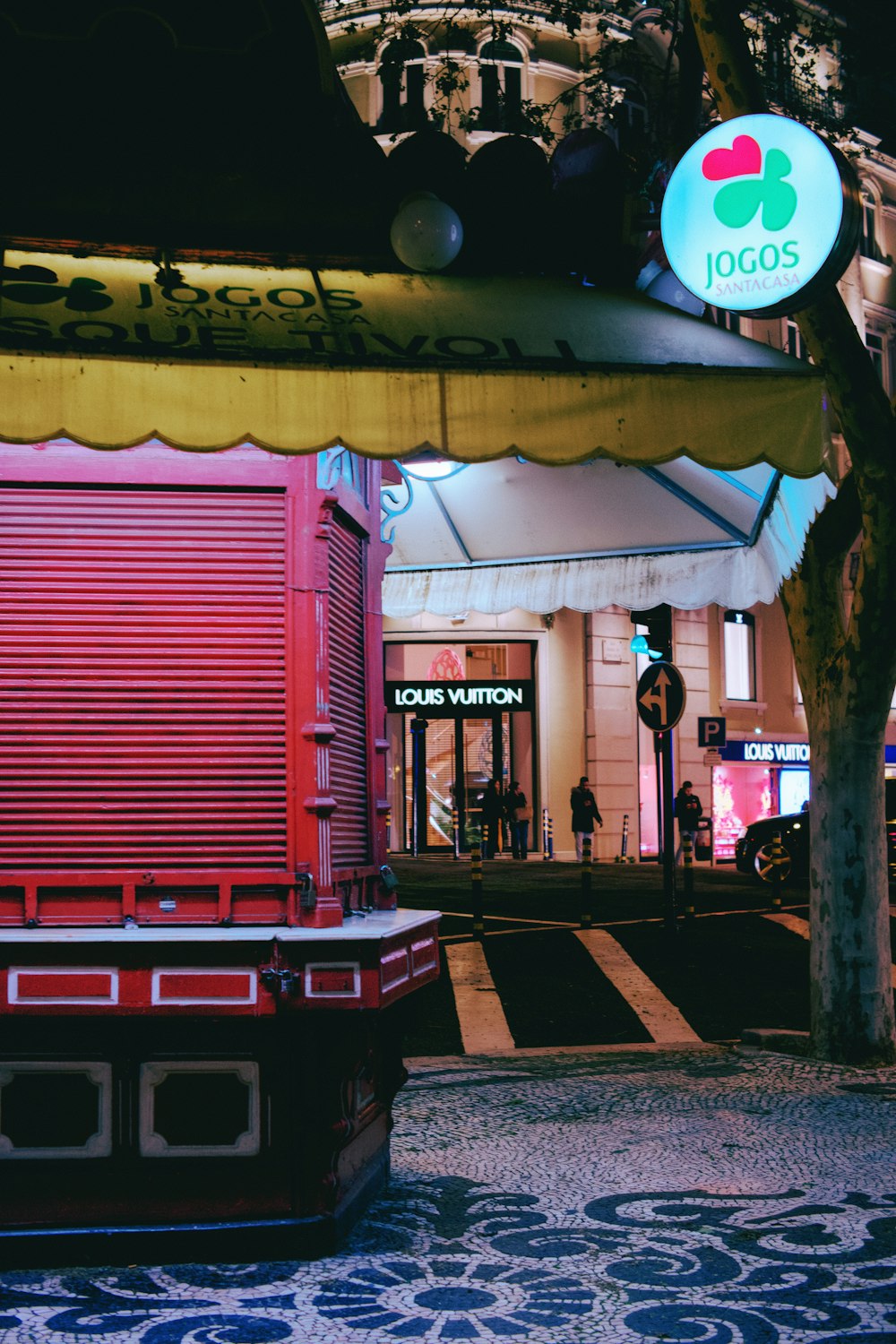 a building with a red door and a yellow awning