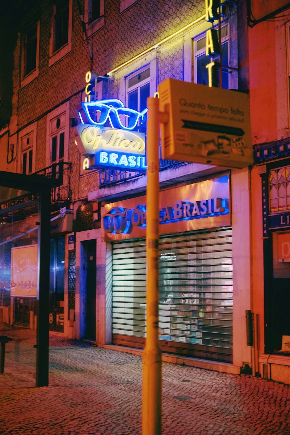 a street sign on a pole in front of a store