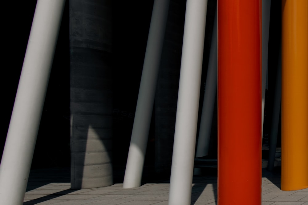 a row of orange and white poles next to each other