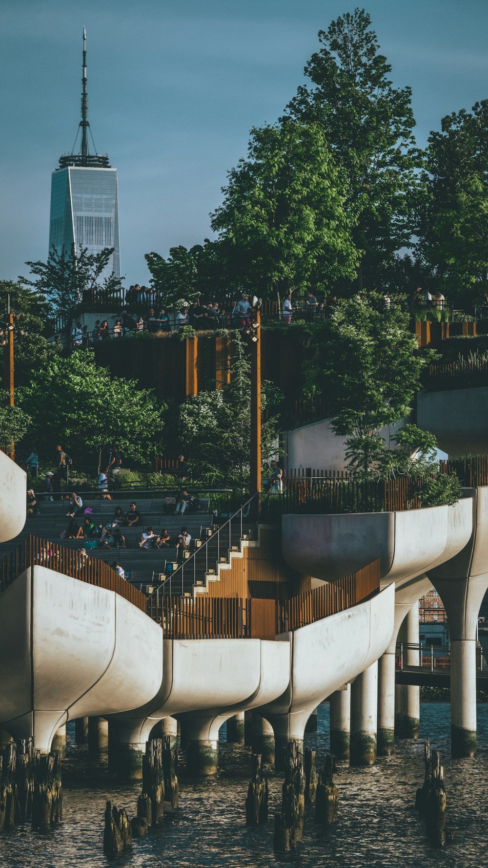 a group of people standing on top of a bridge