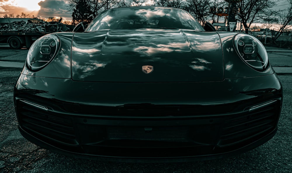 a black sports car parked in a parking lot