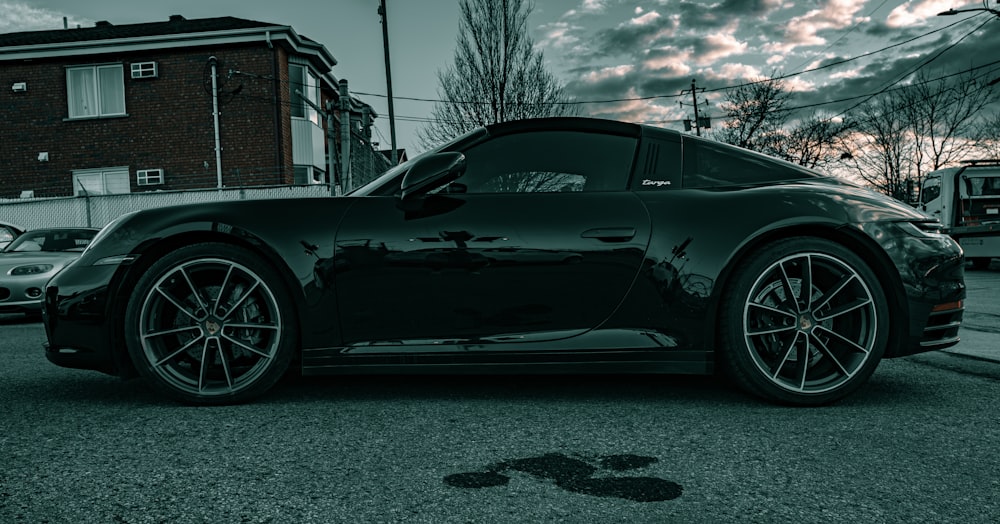 a black sports car parked on the side of the road