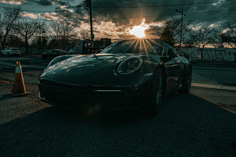 a black sports car parked on the side of the road