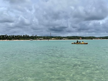 two people in a small boat in the ocean