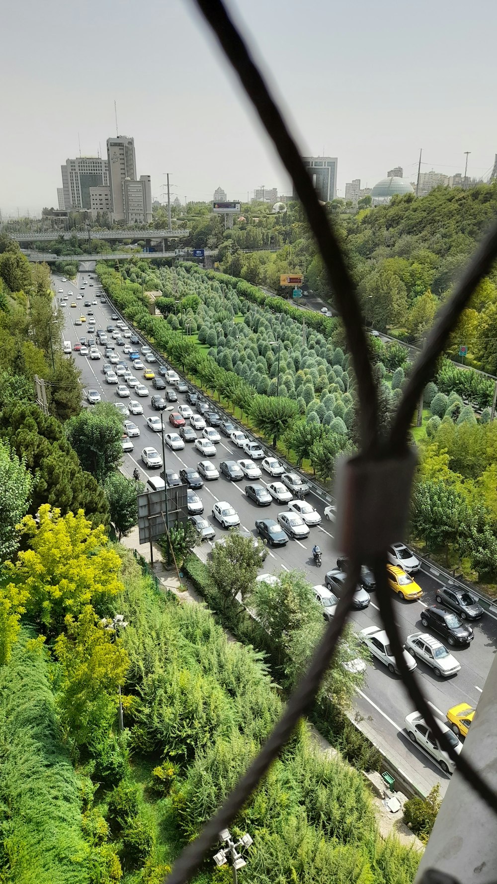 a view of a parking lot through a fence