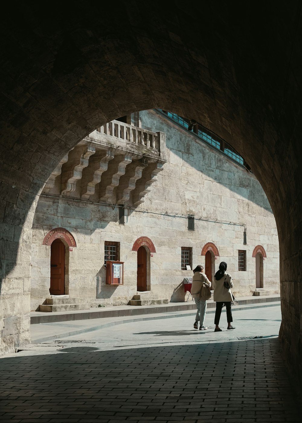 a couple of people that are standing under a tunnel