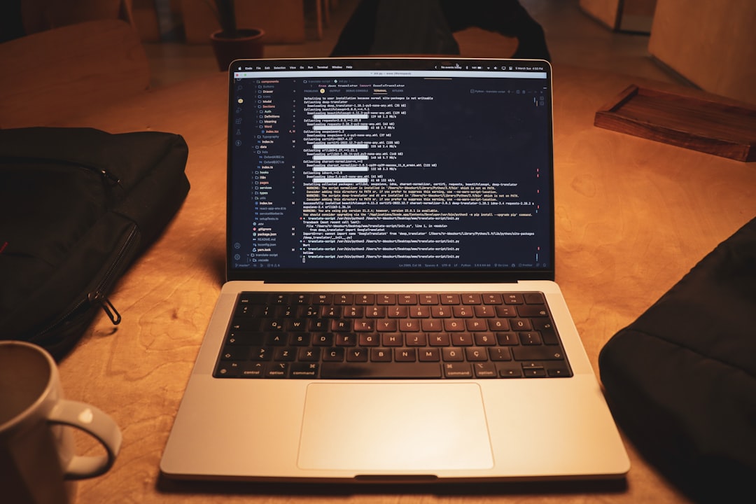 a laptop computer sitting on top of a wooden table,
