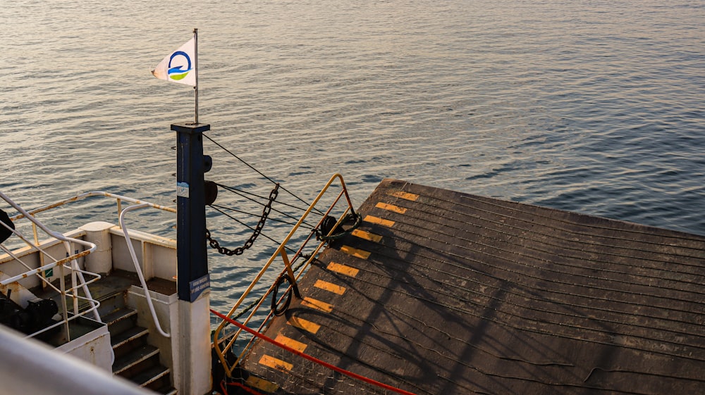 a boat with a flag on top of it in the water