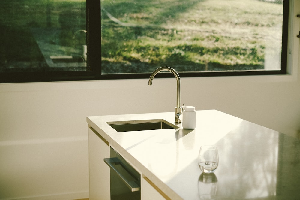 a kitchen counter with a sink and a window