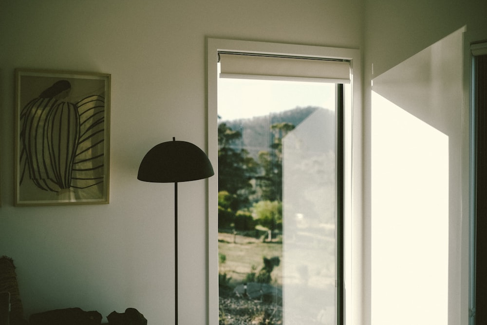 a room with a lamp and a picture on the wall