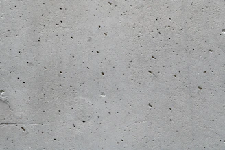 a cement wall with small holes in it