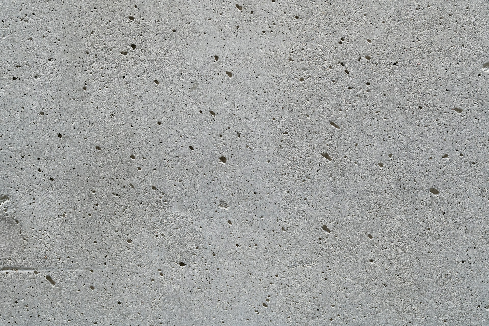 a cement wall with small holes in it