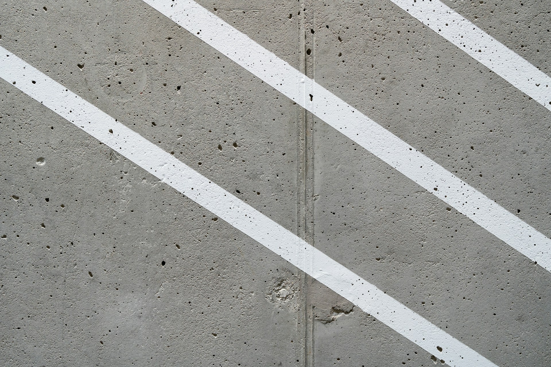 a concrete wall with white lines painted on it