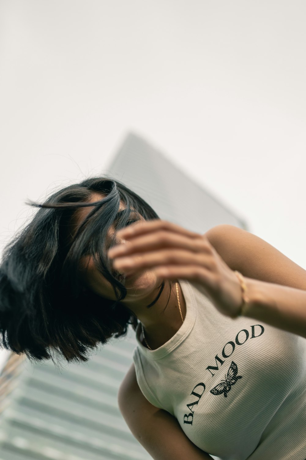 a woman in a white shirt is holding her hands out