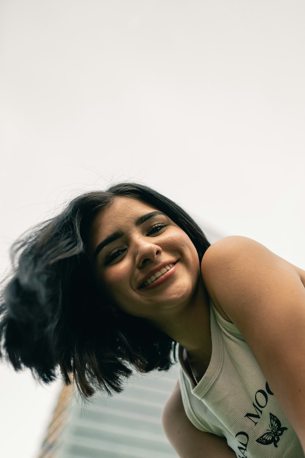 a woman with black hair is smiling for the camera