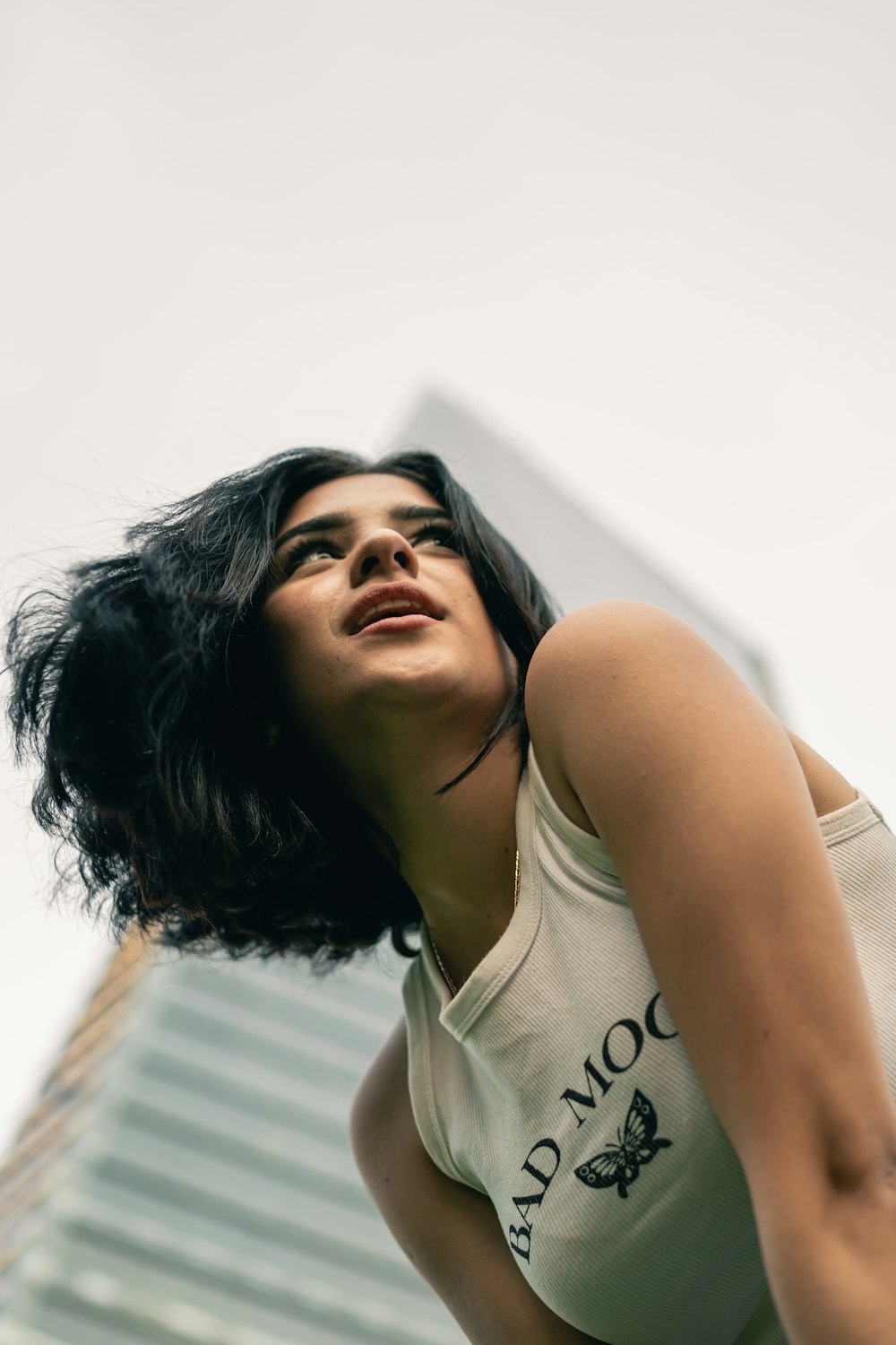 a woman in a tank top is posing for a picture