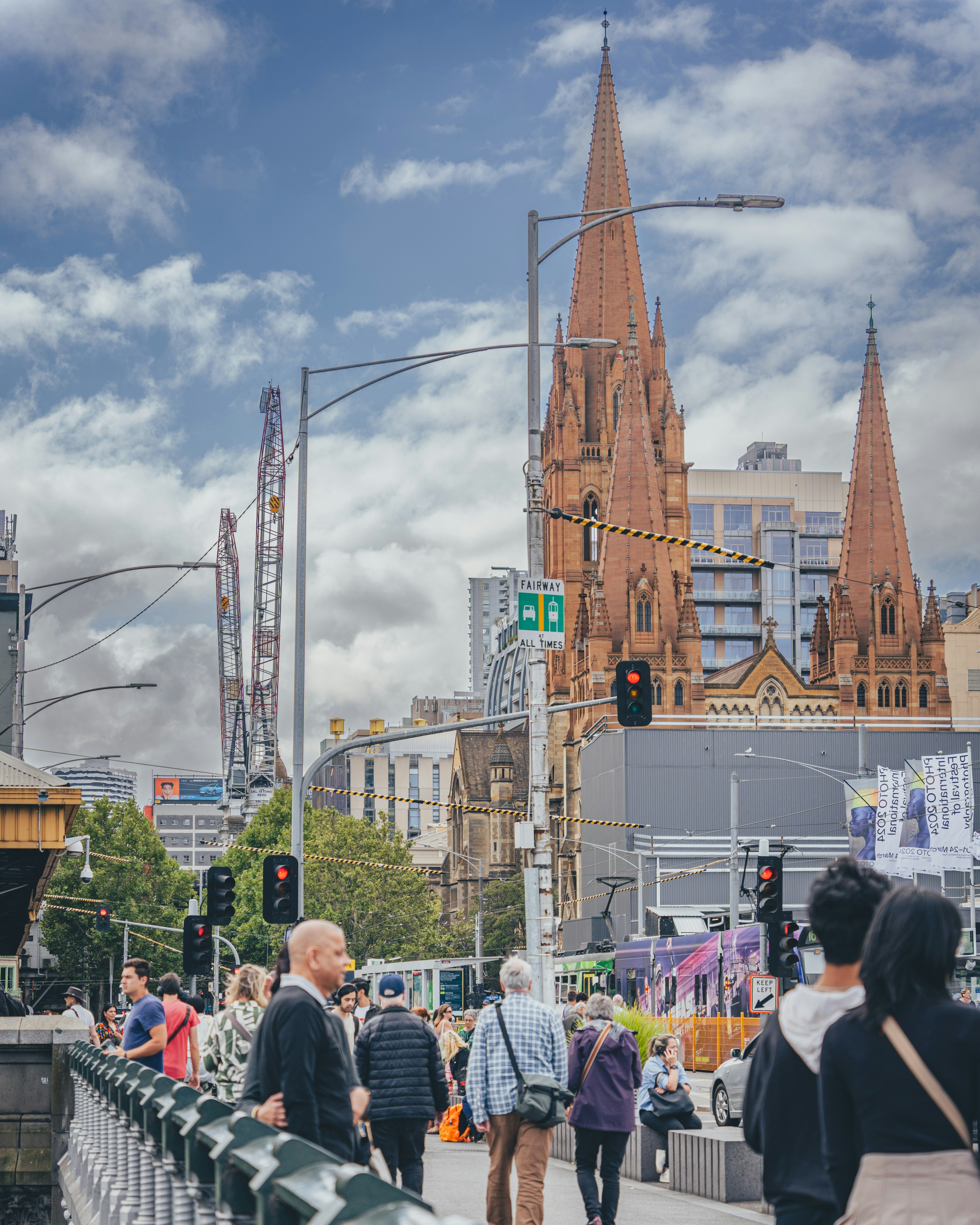 a group of people walking across a bridge
