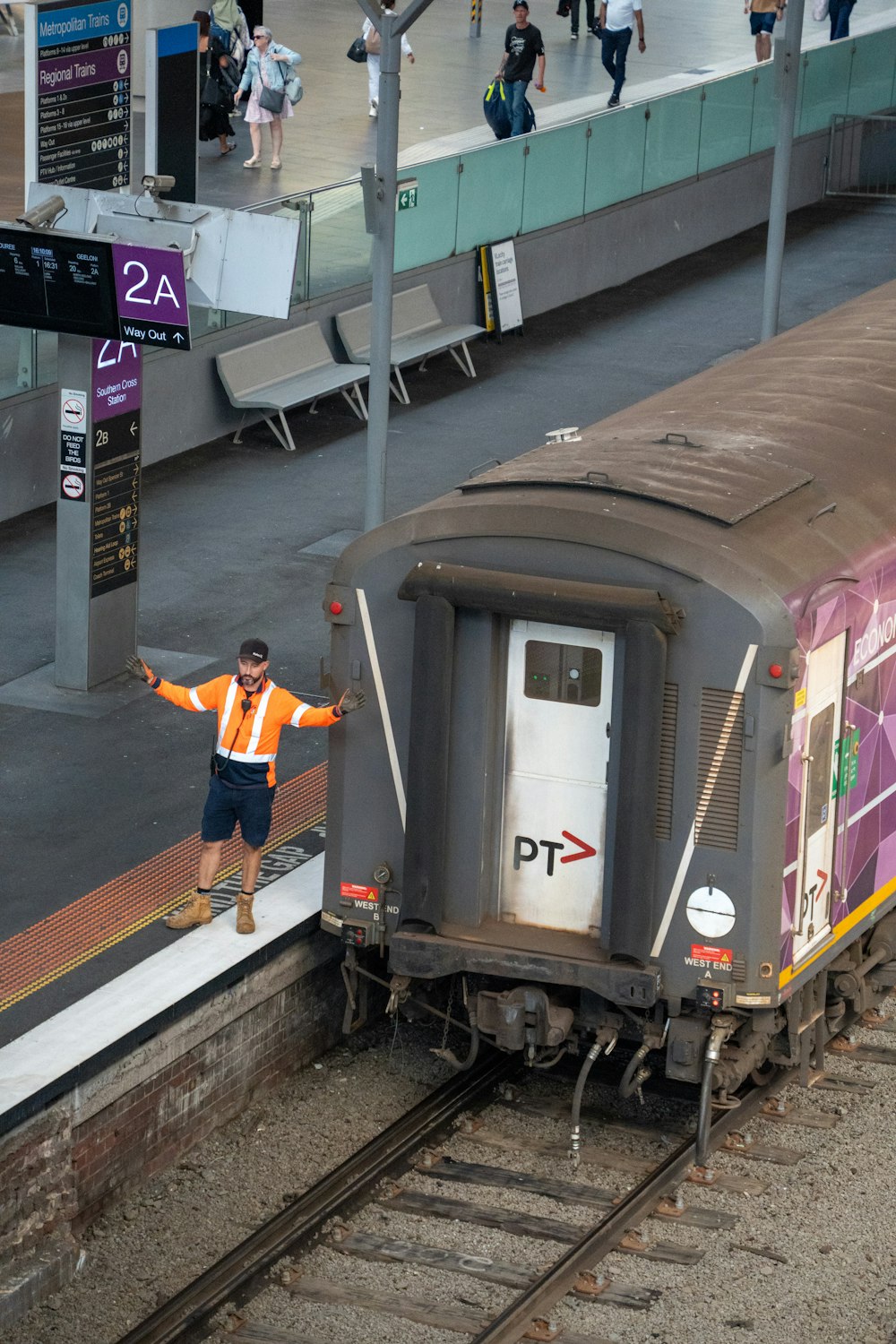 a man standing on a train track next to a train